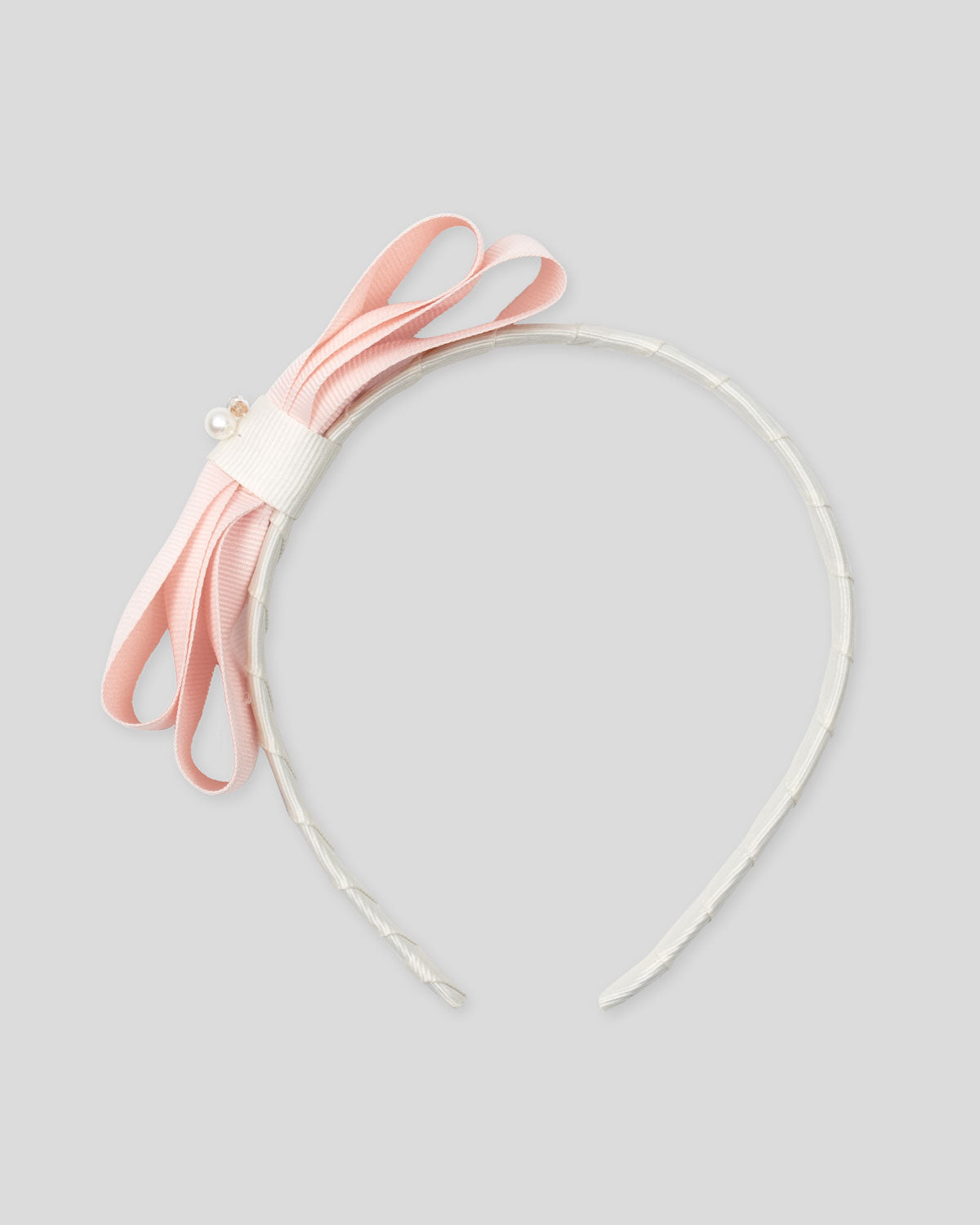 Headband with pink bow for girls.