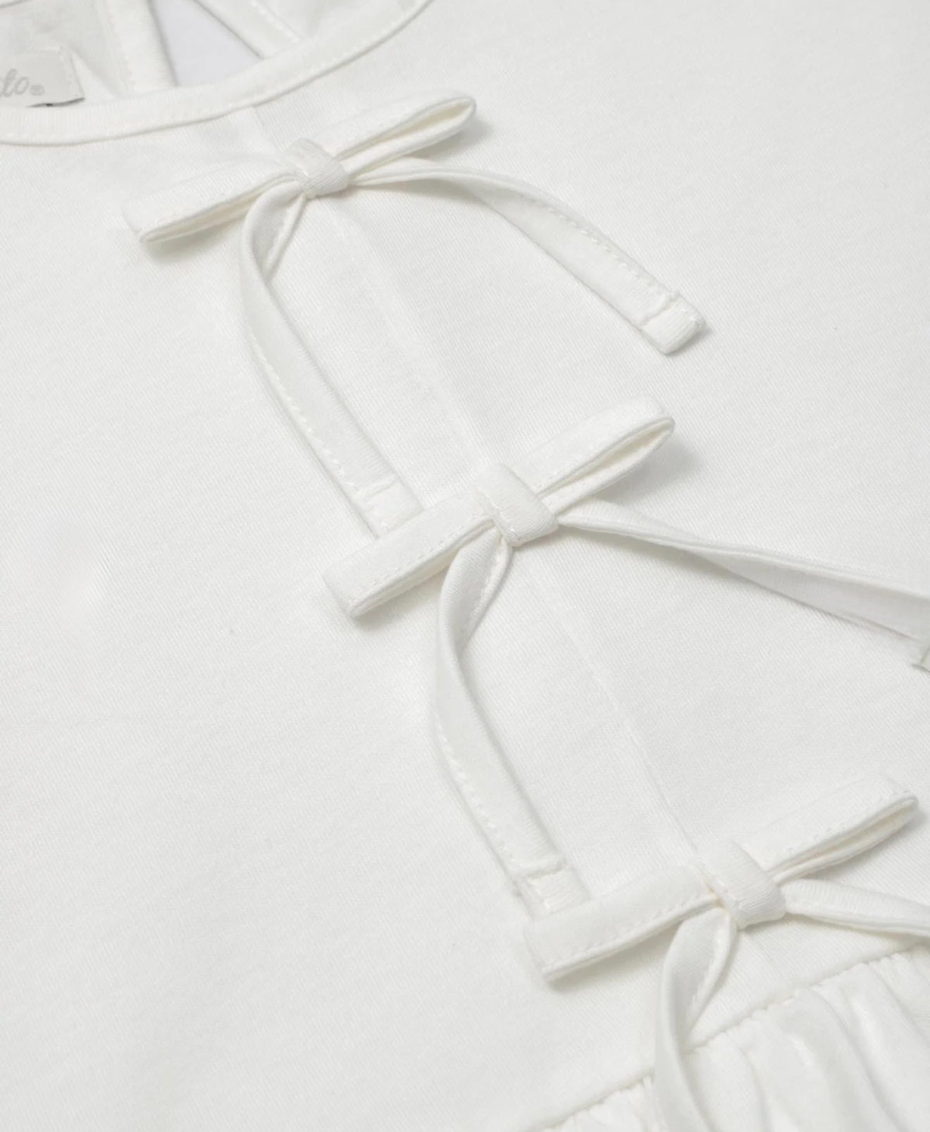 White blouse set with bow detail, finished with a bolero and blue leggings for girls